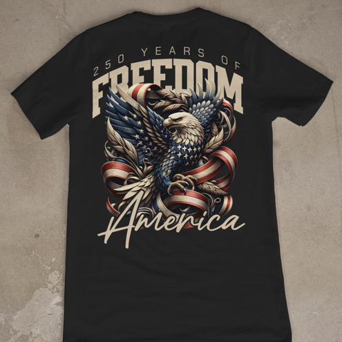 Black t-shirt with eagle and American flag design on a concrete floor