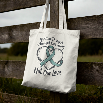 Tote bag with Batten Disease awareness design hanging on a wooden fence.