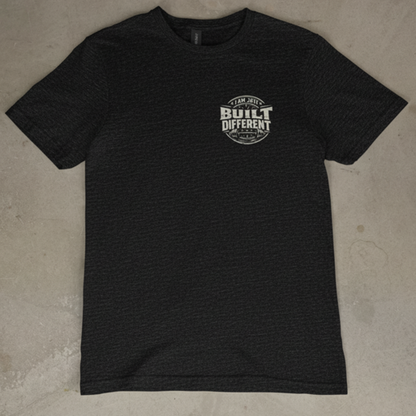 Black t-shirt with a logo on a concrete floor