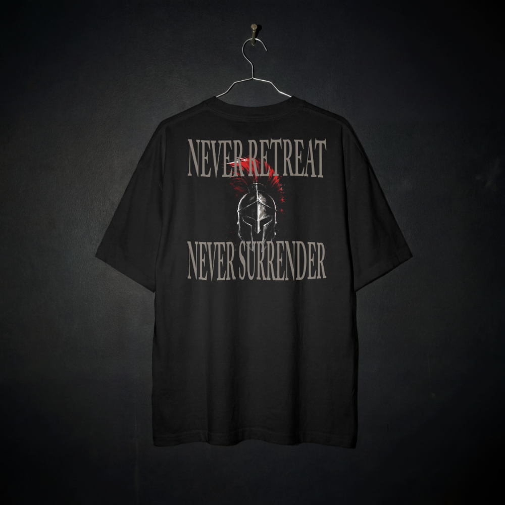 A black short-sleeve t-shirt hanging on a metal hanger against a dark textured background. The back of the shirt features a distressed graphic with the words 'NEVER RETREAT' and 'NEVER SURRENDER' in a light gray stencil font, surrounding a central Spartan helmet illustration with a red crest.