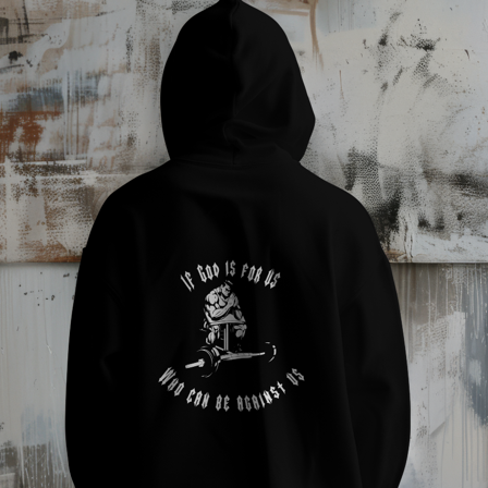 Person wearing a black hoodie with text and graphic design against a textured wall.