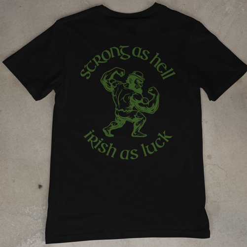 Black t-shirt with green graphic and text on a beige surface